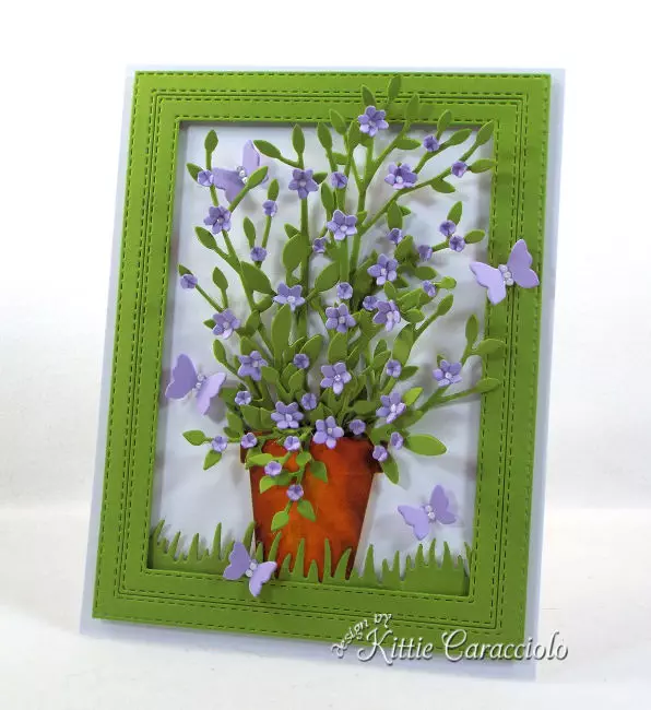 Come see this bright and pretty die cut framed potted plant and flowers that is perfect for any occasion.