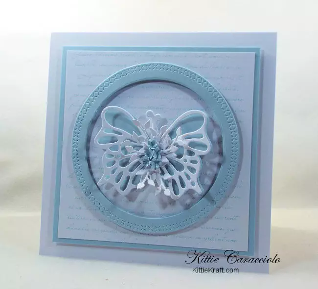 Come see how I made this pretty circle framed die cut butterfly card with a French script background and tiny flowers.