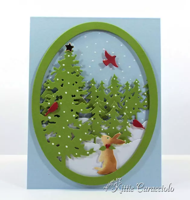 Come see how I made this pretty die cut pine tree snow scene