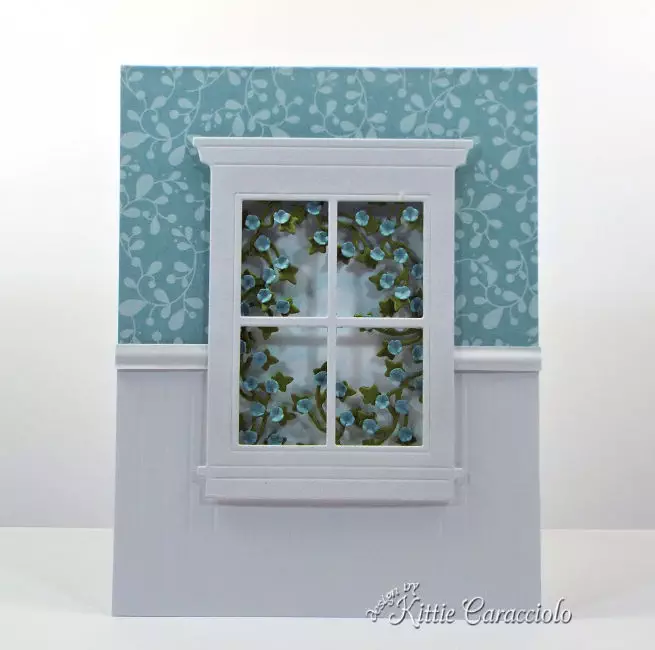 Come see how I made this elegant die cut window scene with ivy and flowers.