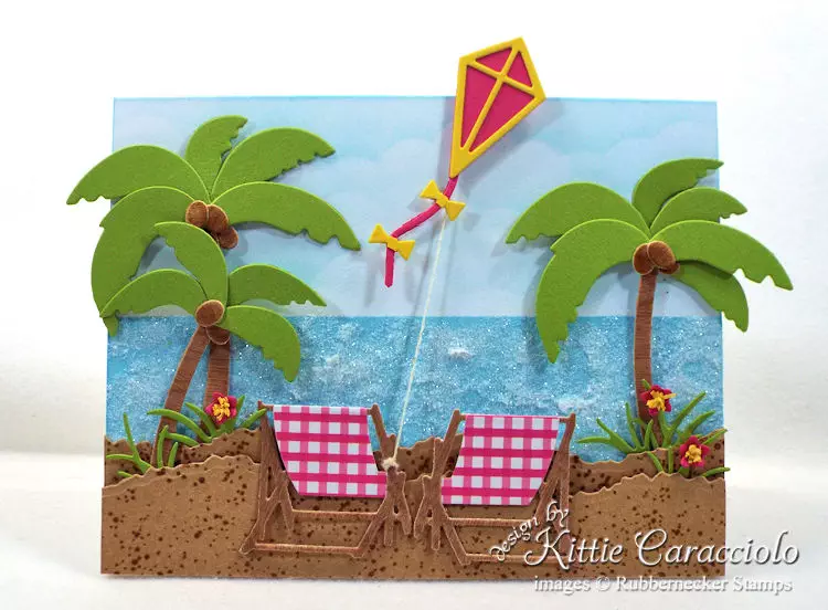 Come see how I made this sparkly beach chairs scene card.