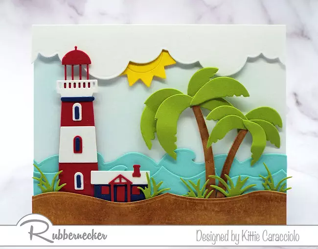And image using altering die cuts in size to make a die cut lighthouse and palm tree fit a differently sized card