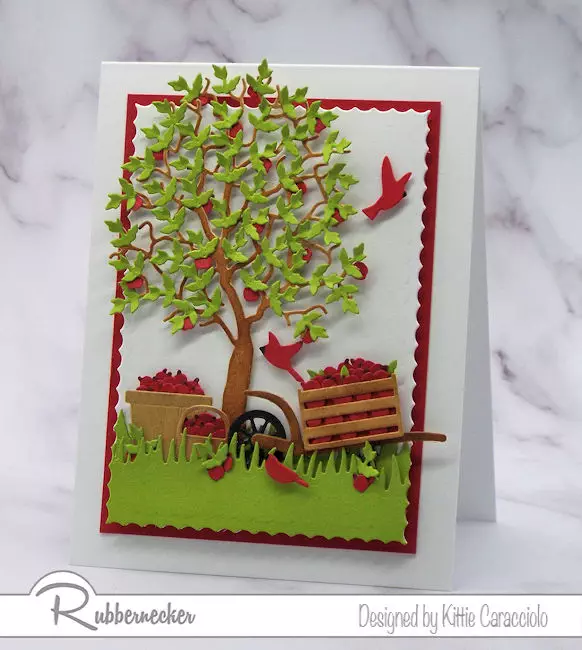 A card made using multiples from a leaf die cut placed onto a die cut tree to make a focal image on a handmade greeting card