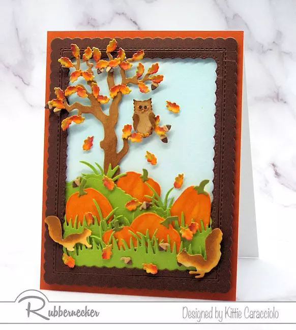 One of my fall cards with die cut and hand colored squirrels, pumpkins and an owl in a tree complete with tiny falling leaves