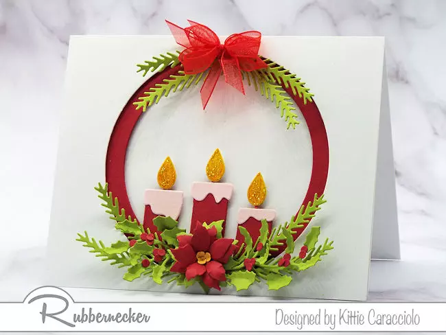 an example of how to make your own Christmas cards showing a die cut candle arrangement surrounded by die cut greenery