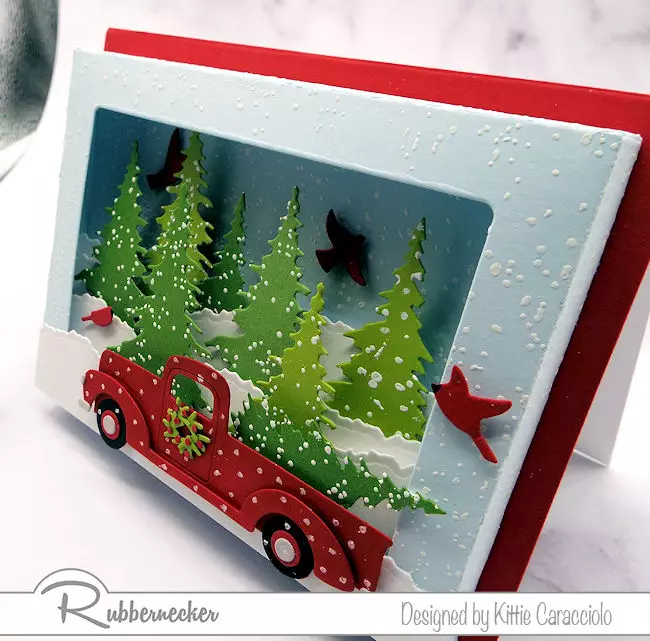 A closeup side view of the card base and decorated die cuts used on a shadow box card die to make a dimensional card