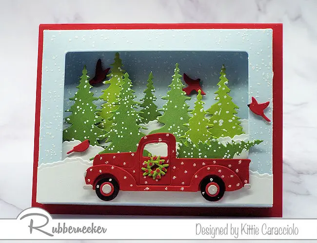 A dimensional card made using die cuts and a shadow box card die to create a 3D scene