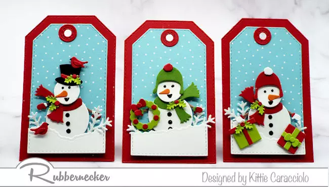 a set of three snowman tags made using die cuts showing different holiday themed scenes