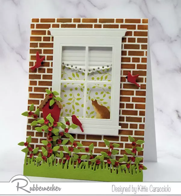 A window card that looks like an actual window complete with a tiny window shade and a kitty on the sill