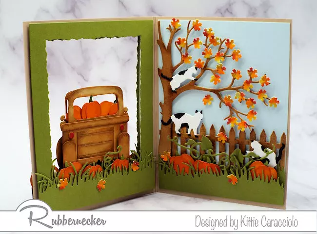 The inside scene from a handmade double sided open frame card taught through a video tutorial and made using paper crafting dies from Kittiekraft by Rubbernecker