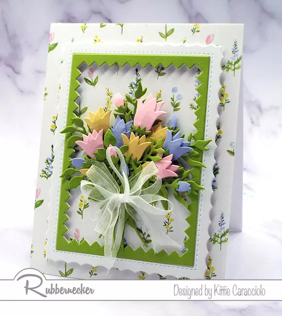 a paper flower bouquet card with die cut flowers against a patterned background