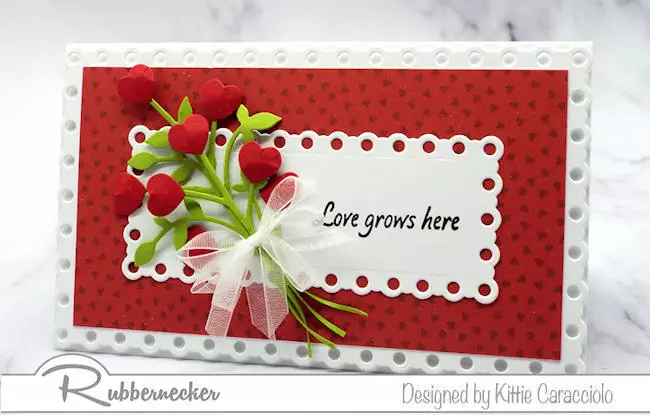 a handmade card in red and white with pops of green made using flower and mini slimline card dies