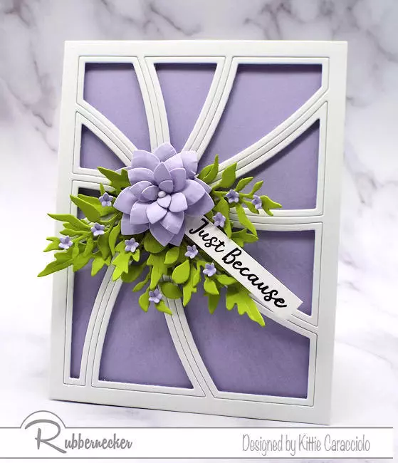 a white off set pin wheel cover die set with a beautiful die cut purple flower all from Rubbernecker