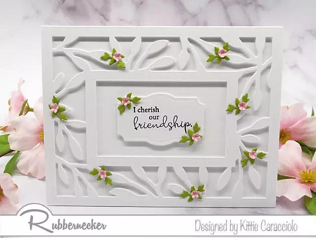 the new leaf frame cover die from Rubbernecker combined with tiny die cut flowers creates a stunning handmade greeting card