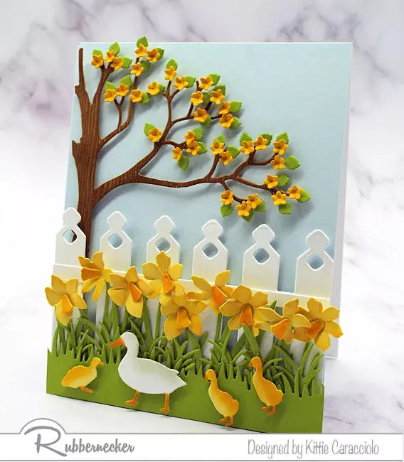 die cut daffodils, inked and shaped for realism, adorn a handmade greeting card with spring motifs