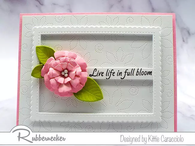 pierced cover dies can be used to create gorgeous backgrounds for handmade cards, as on this one with a dimensional die cut floral focal element in soft pink