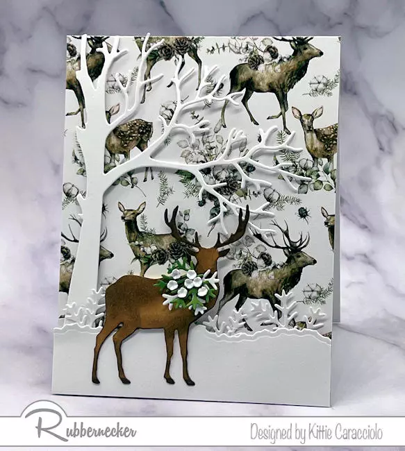 One of my designs for handmade winter cards with deer made using patterned paper in the background and dies to make the details.