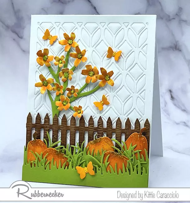One of my handmade Fall card ideas with classic pumpkins, pale orange flowers and a graphic, textural white background made with a simple cover die.