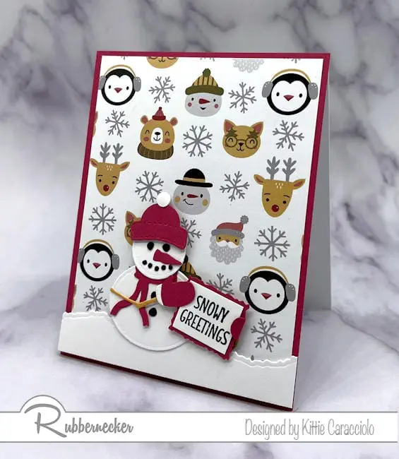 A winter themed patterned paper and an all in one die set come together on this quick and easy die cut snowman card.