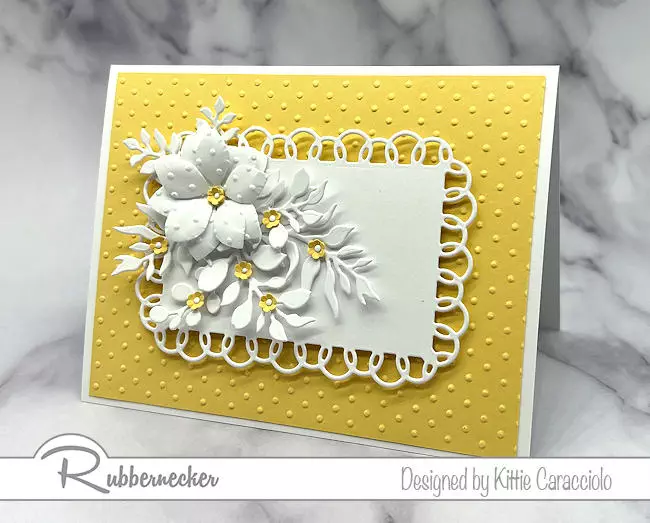 An embossed polka dot flower card with polka dots on the yellow background and the white flower's petals.