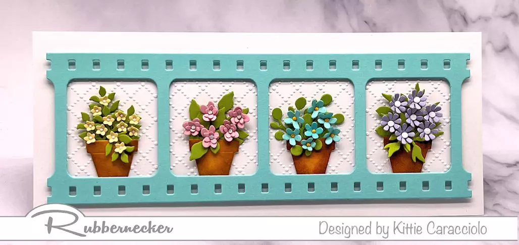 Learn how to color die cut flower pots like the four flower filled examples on this handmade slimline card.