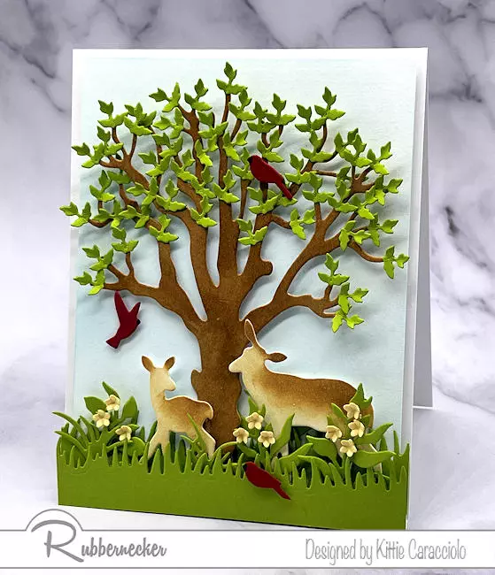 Two peaceful card stock deer colored using pro tips for inking die cuts graze under a detailed die cut tree.