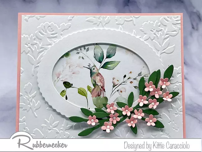 Learn how to highlight a patterned paper as shown in this handmade card that frames a sweet hummingbird with a die cut oval frame.