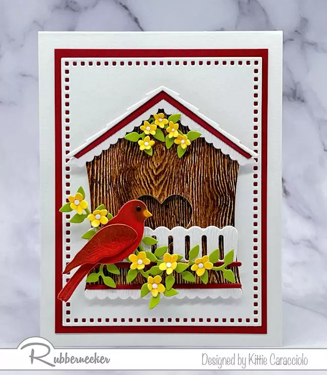 A realistic little home for this die cut cardinal on this handmade card was made using add on dies to make a birdhouse from a garden shed die cut.
