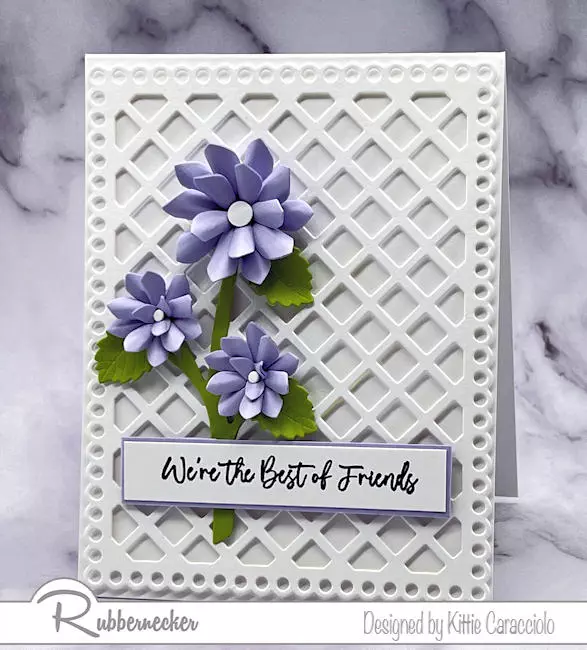 A simple yet stunning white on white die cut lattice card with just a few shaped die cut lavender flowers.