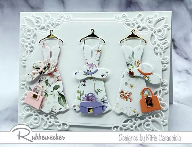 A beautiful feminine handmade card decorated with die cut paper pieced dresses cut out of different scraps of floral patterned paper.
