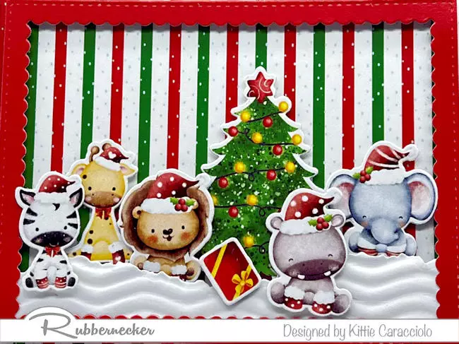 Pre-printed and die cut baby animals arranged on a festive background for one of the cutest inexpensive handmade holiday cards you can make this season.