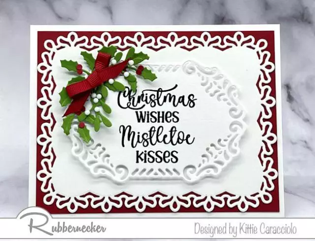 Easy to use products from Rubbernecker went into creating this easy die cut layered Christmas card for the white on white layers, holiday foliage and cheerful holiday sentiment.