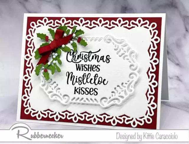 White one white layers with pops of red and green die cut decorative foliage make this easy die cut layered Christmas card perfect for making multiples to send this year as your holiday card.
