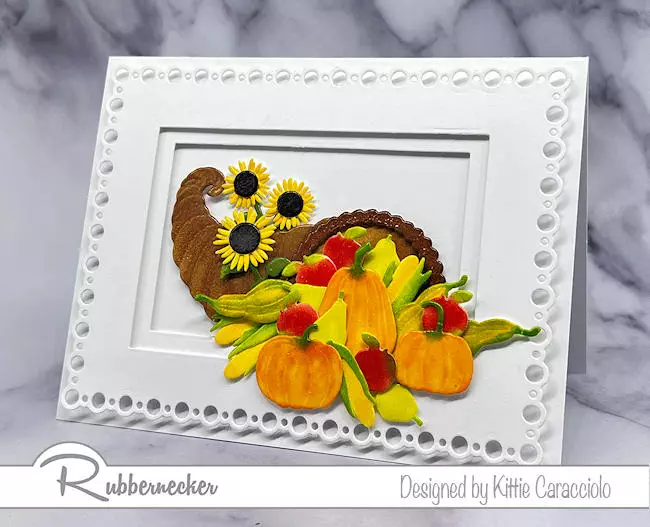 A beautiful handmade fall card using a layered rectangle die cut frame to set off the die cut cornucopia, fruits and vegetables.