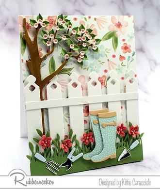 one of my early spring card ideas loaded with die cut details of garden boots, a picket fence and pretty pink flowers